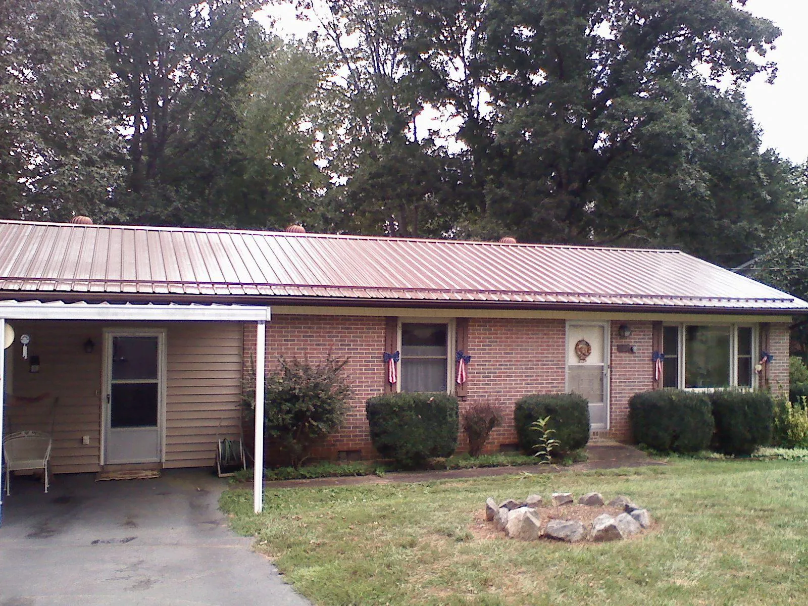 Bronze metal roof and carport on a brick ranch home — Roof Repair work by our crew in Coal Creek